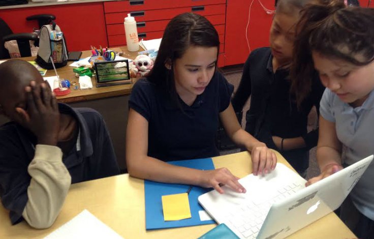 PATHS has taught Sandra Baca (right) more about her emotions. She acknowledges she can be bossy. She realized she was shutting Jeramiah Nichols (left) out of a group project on bullying, and later included him. She says PATHS has helped her in conflicts with her sister. “I understand now how to relax and bring myself down and not really think about it,” she says. 
