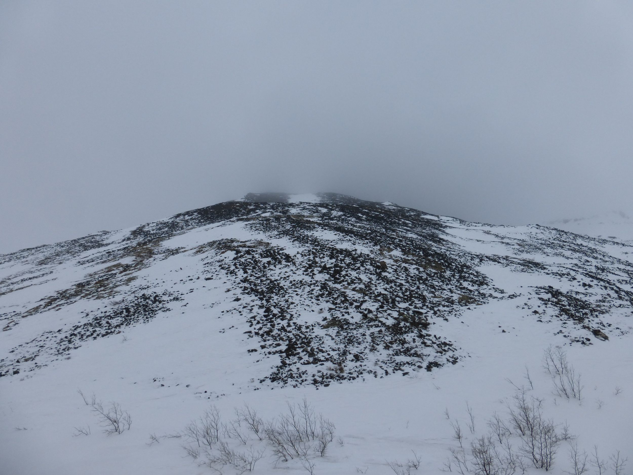 Beside me, steep peaks engulfed in clouds