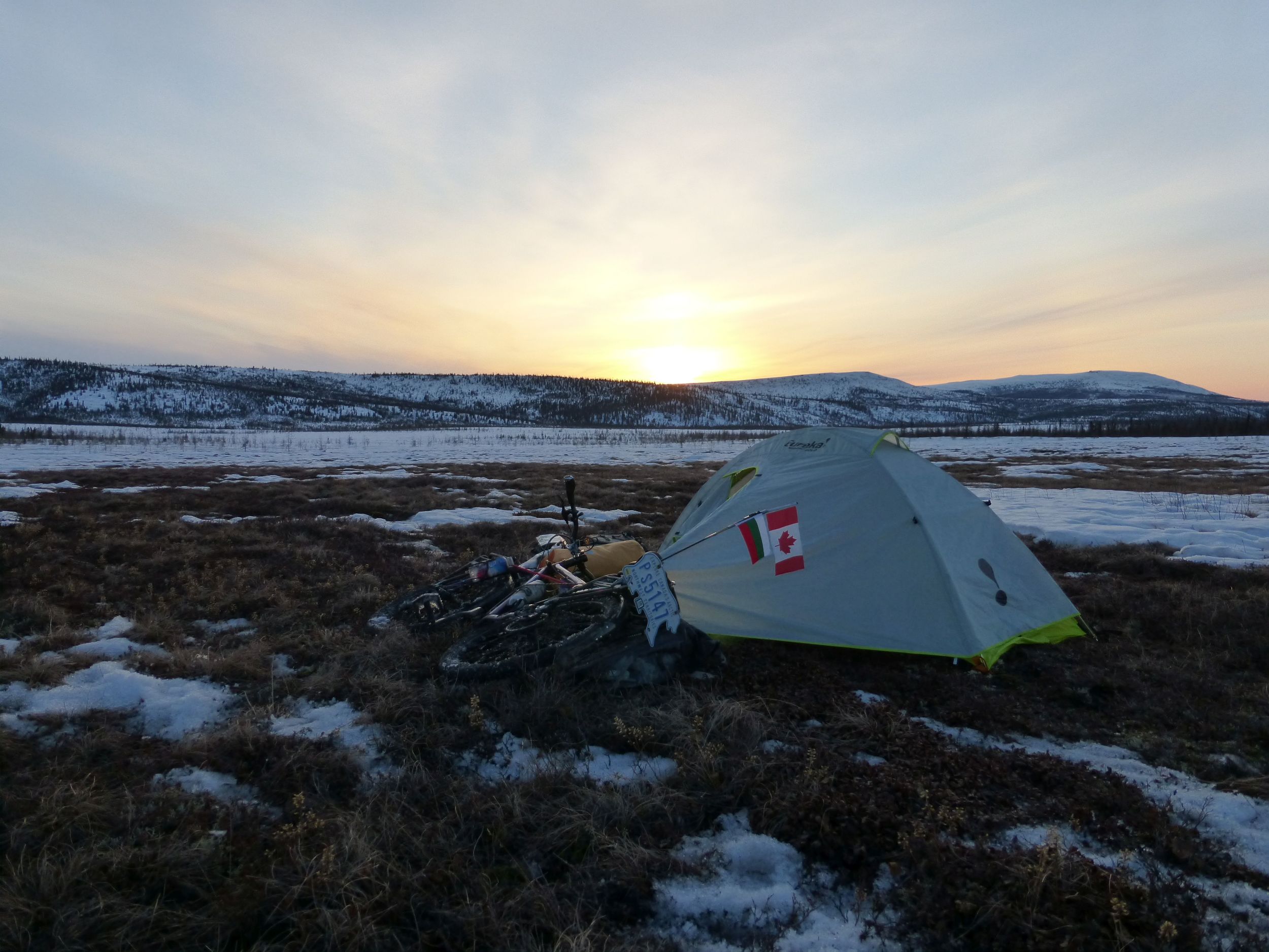 I spot a patch of tundra not covered in snow beside the road. It's a good place to camp.