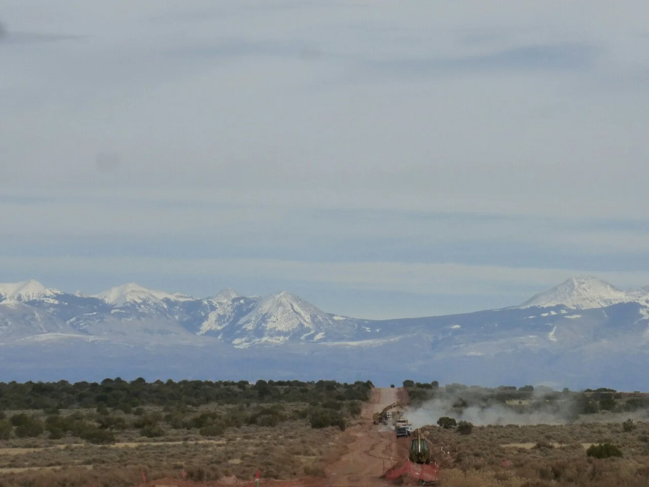 Workers were running a pipe along the road to the oil rigs on the mesa. Occasionally a fully loaded tanker would make its way down the dusty road.