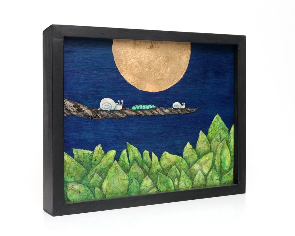 A large golden moon glows in a deep blue sky. Two snails and a green caterpillar rest on a branch above sheet music patterned leaves. Peaceful, whimsical scene using vintage maps layered with ink wash