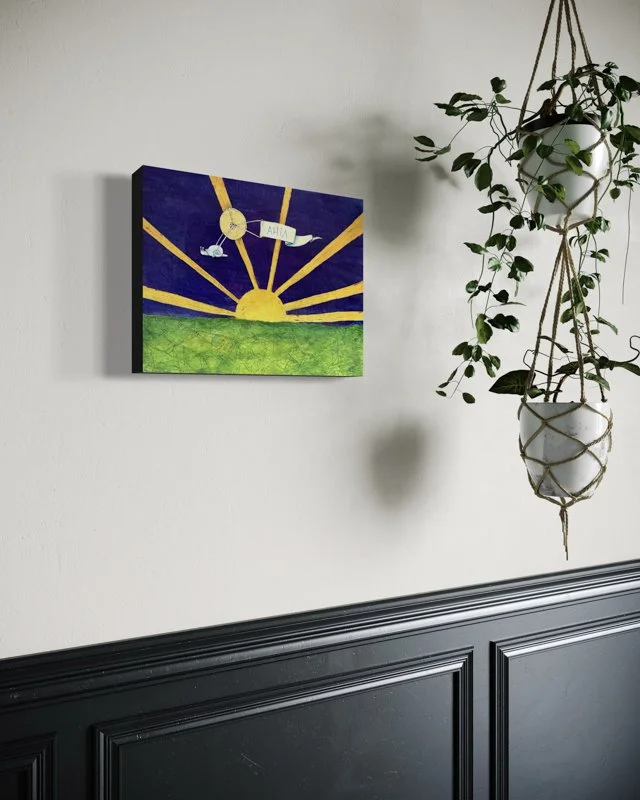 A yellow sun rises over a green, map-like landscape with golden rays. A snail pulls a banner reading AHIA. Features watercolor and collage pieces of aeronautical maps layered with ink wash