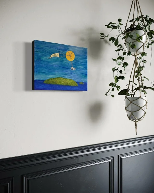 A snail flies in front of a large gold sun, holding a banner that says ALOHA. Below, a green island is surrounded by blue ocean and sky in watercolor, layered collage and ink wash accents