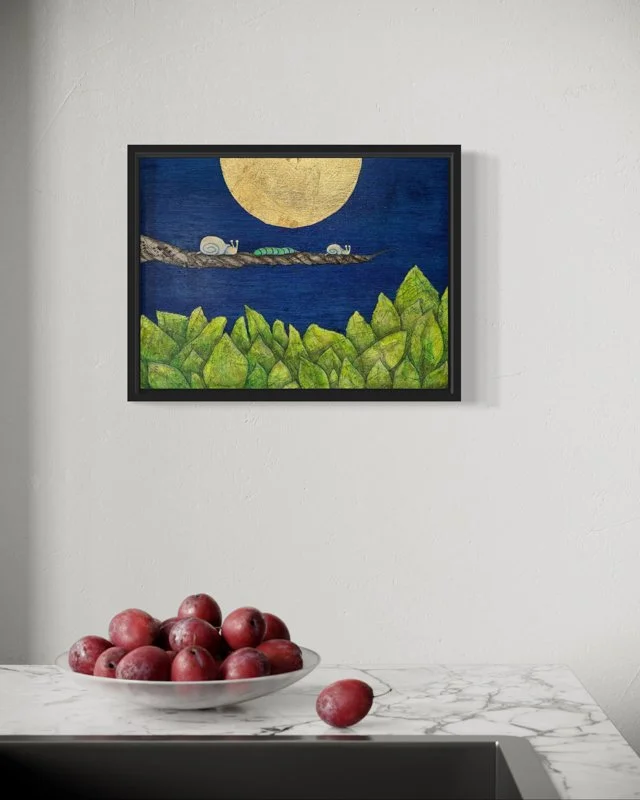 A large golden moon glows in a deep blue sky. Two snails and a green caterpillar rest on a branch above sheet music patterned leaves. Peaceful, whimsical scene using vintage maps layered with ink wash