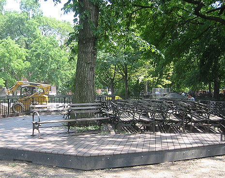 Benches are lined up on the new deck awaiting repairs and a fresh coat of paint. The deck was created to protect the roots of the ancient elm. The surface will be built up to meet the top of the deck so there will be no problem for the small dogs reaching it.\