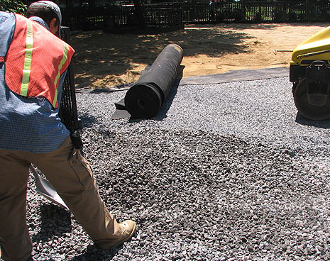 Close up of the materials that create the running field for the Tompkins Square dog run. The gray rock goes below grade for drainage, the brown mix in the background forms the smooth, paw-friendly running surface