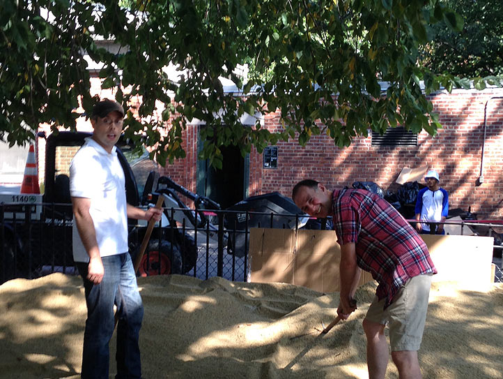 Courtney and Garrett (Java, Kai & Gabriel) begin spreading the sand in the small dog run