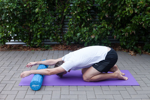 Lats stretch Sit your hips back towards your ankles with your arms on the roller. Breathe in through the nose and expand the lower ribs. As you breathe out, gently sit the hips back further and lengthen the arms away. You should feel a nice stretch though the back of the shoulders and lower back.
