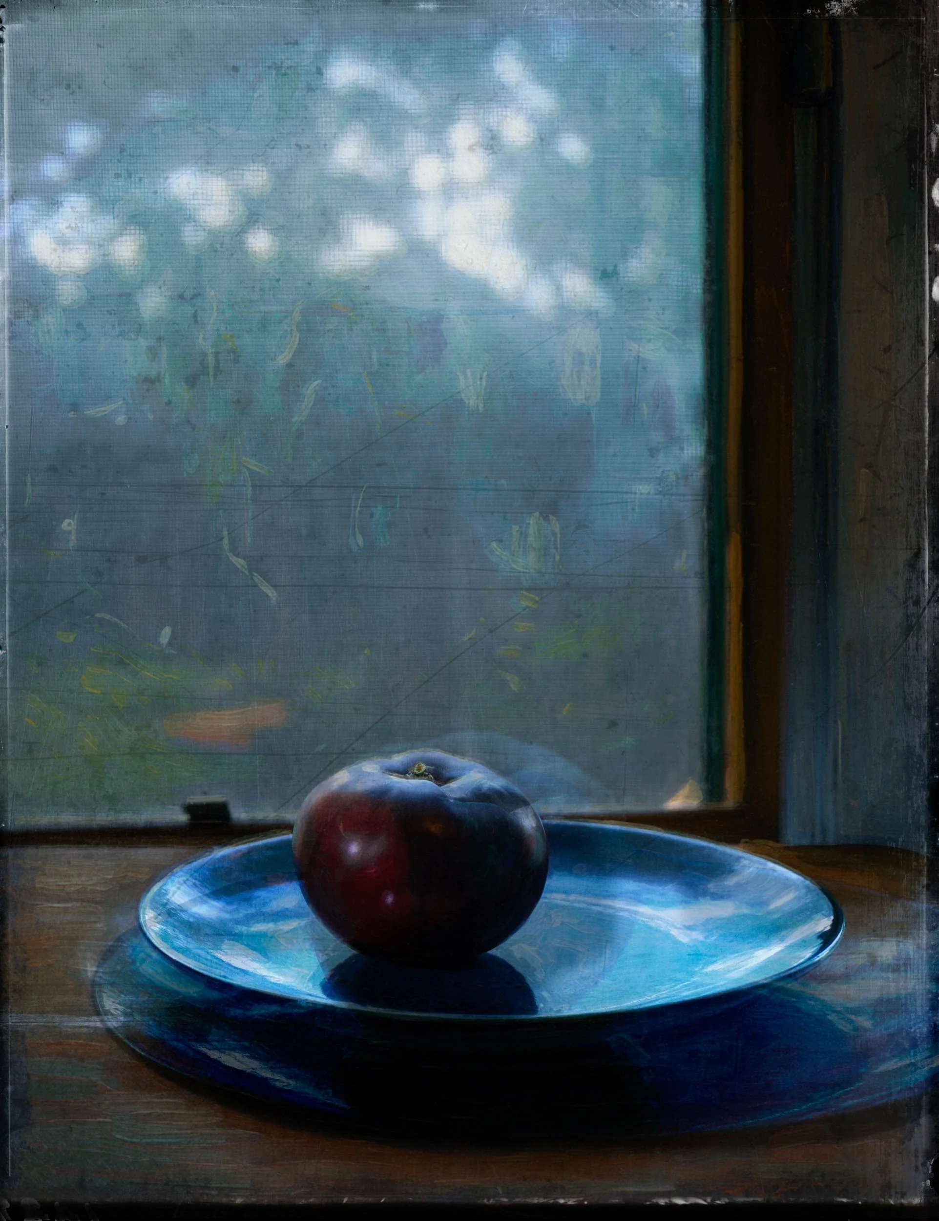 Black Tomato on a Blue Dish