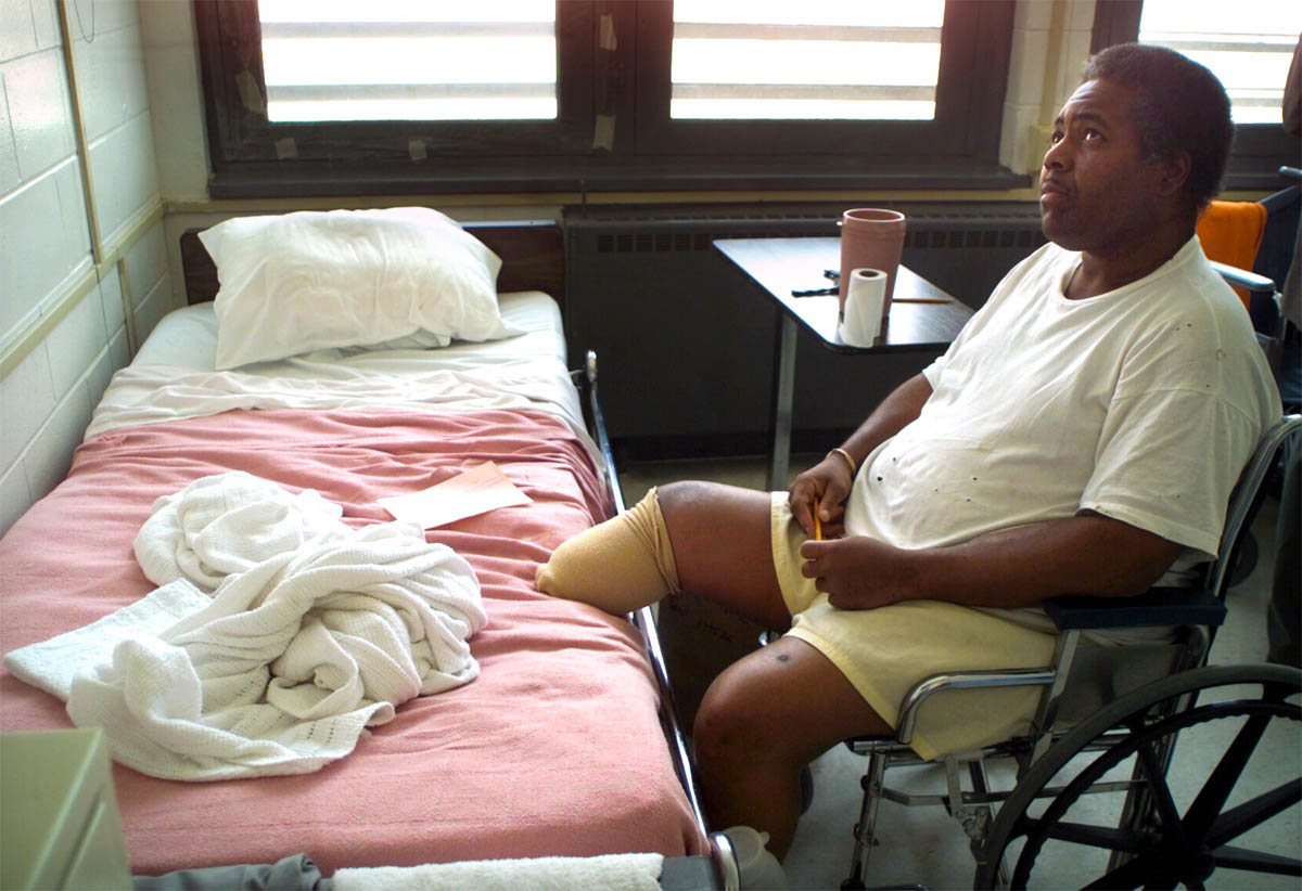 An inmate who lost his leg to an untreated infection spends his days watching TV in the prison infirmary.