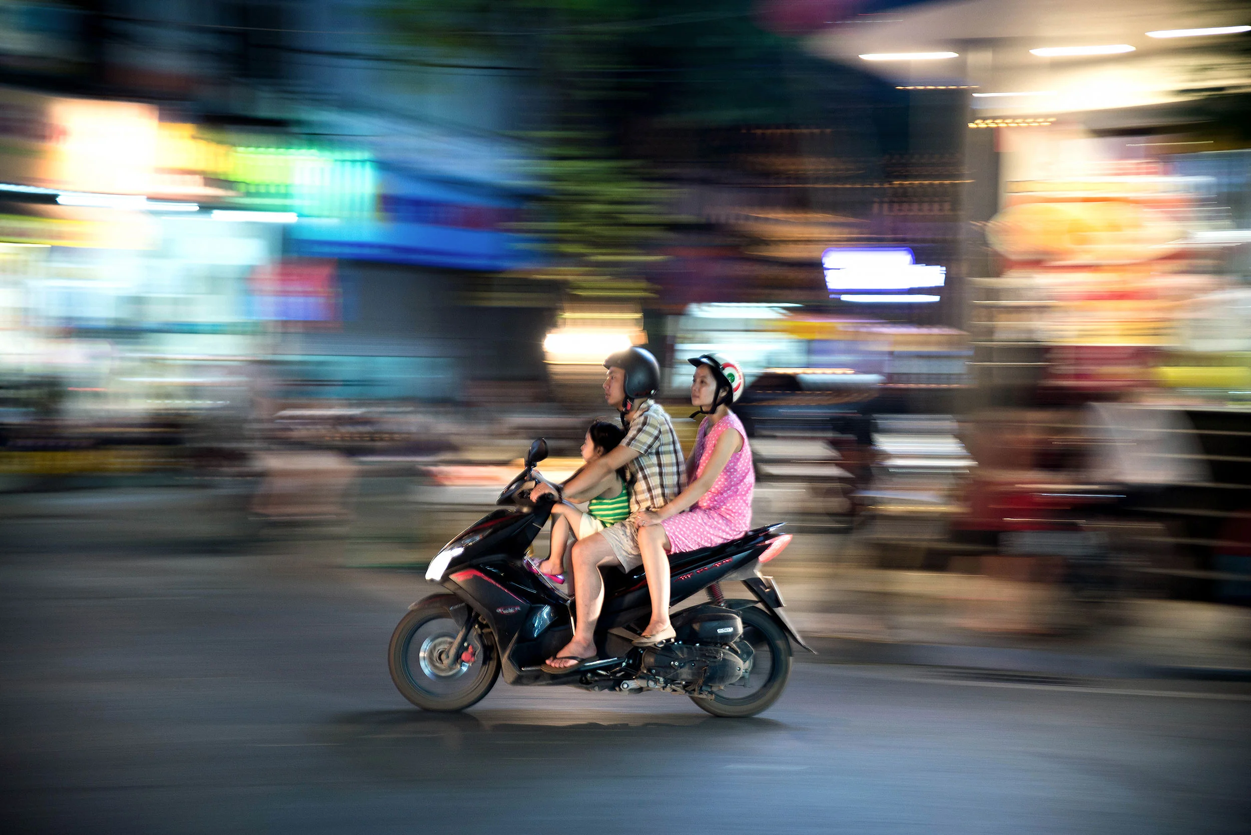 A family rides on a moped together in Hanoi