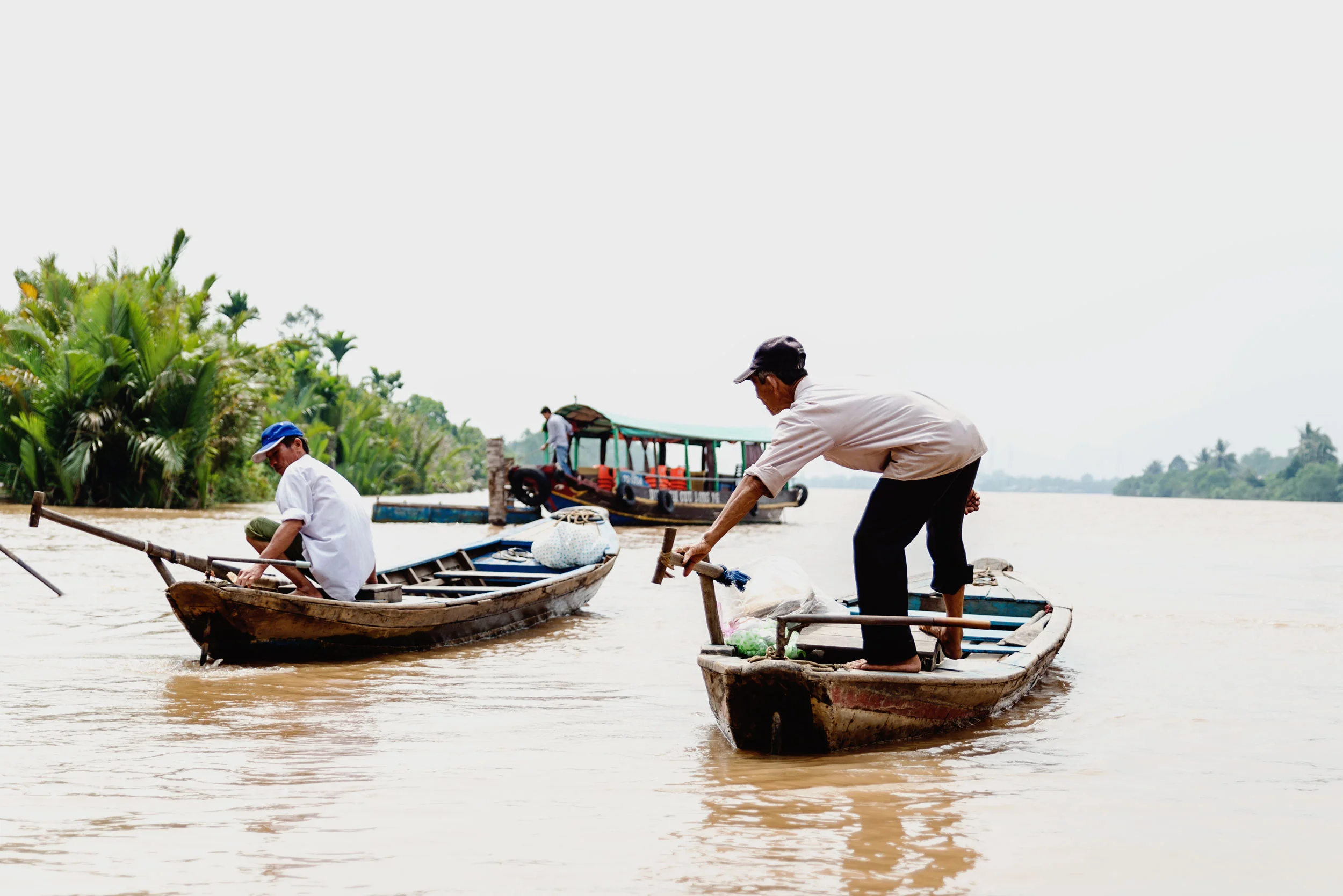 Locals on a boat on the Mekong river in Vietnam