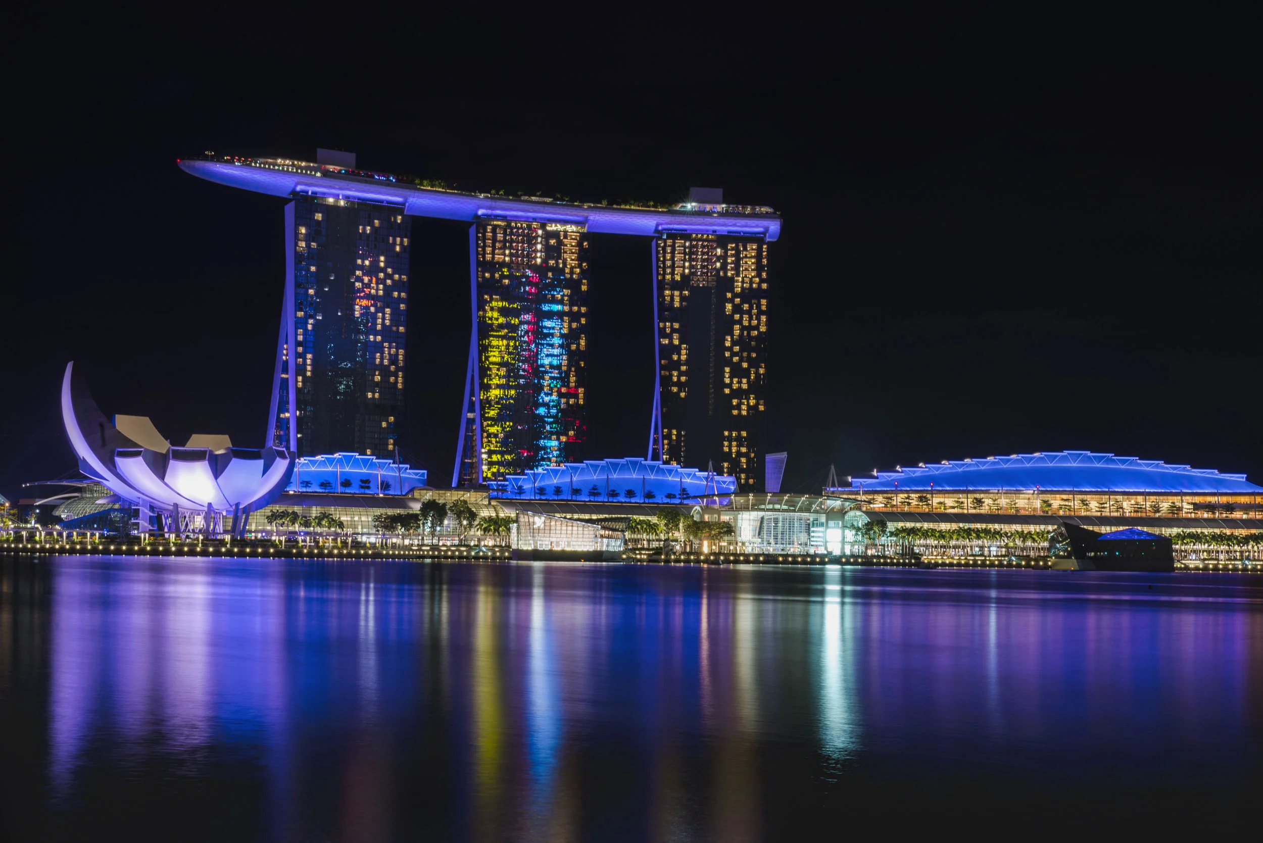 The lights from Marina Bay Sands reflects off water in Singapore