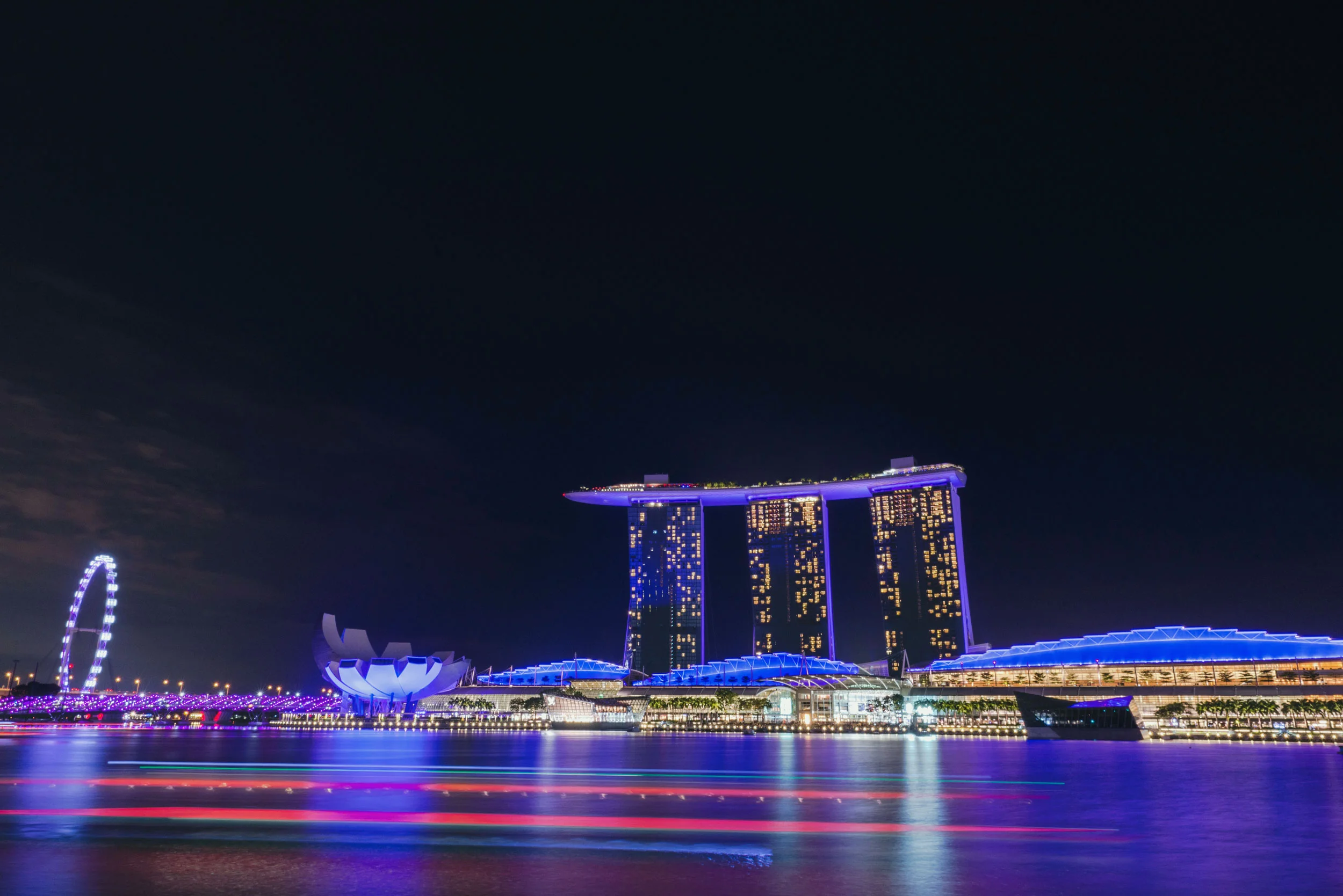 A boat streaks by the Marina Bay Sands in Singapore