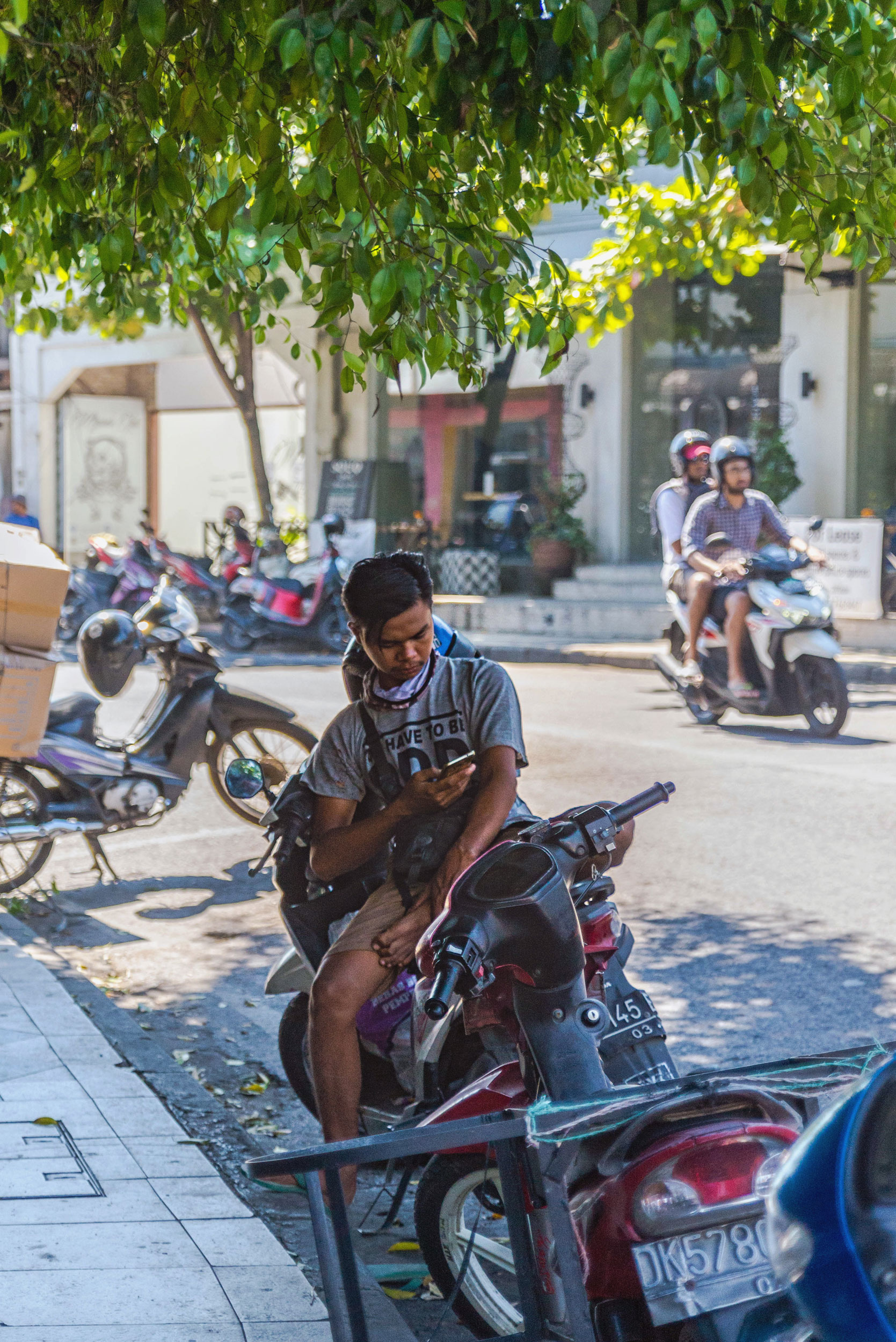 A man sits on his moped in Bali.