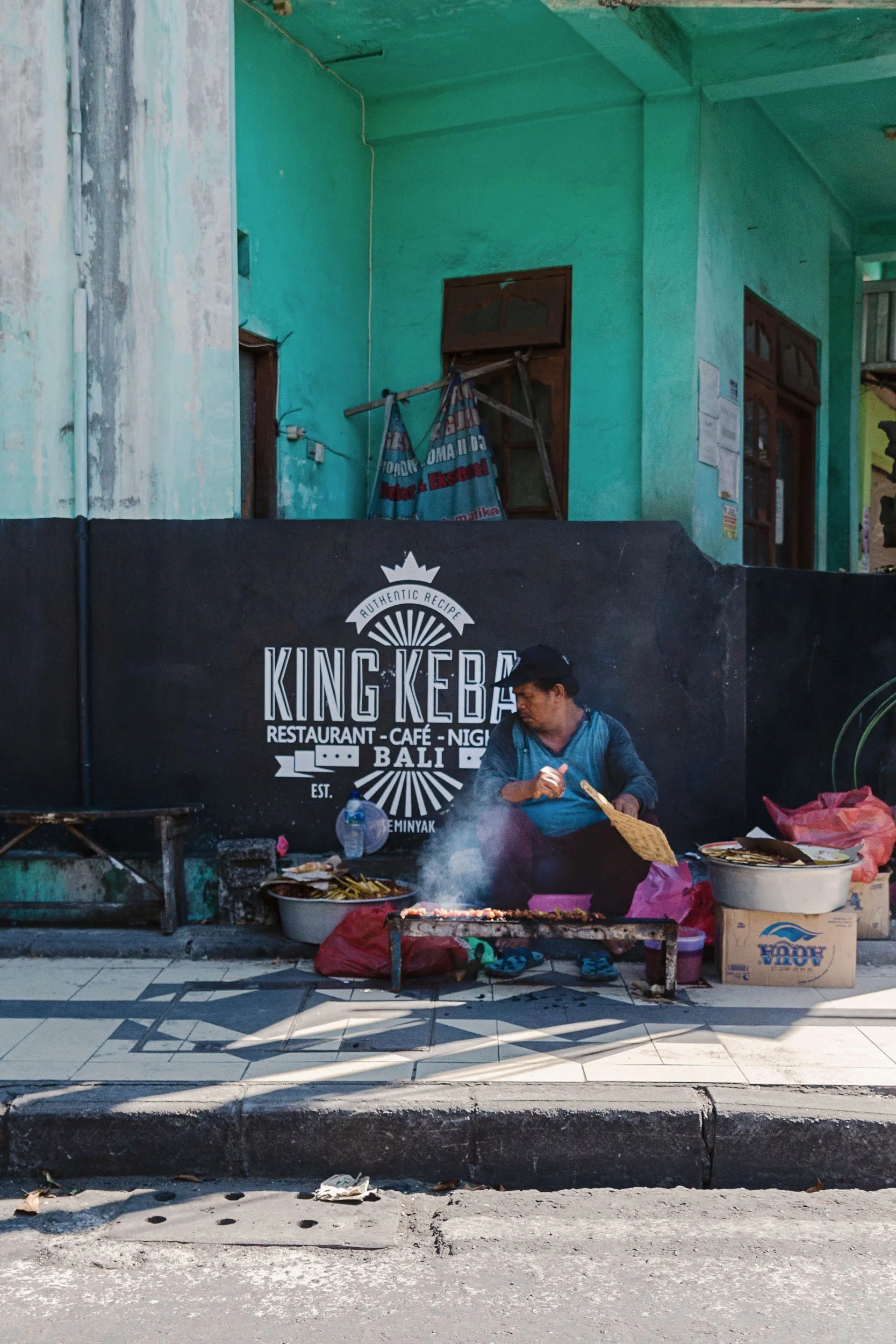 A man grilling on the street in Bali