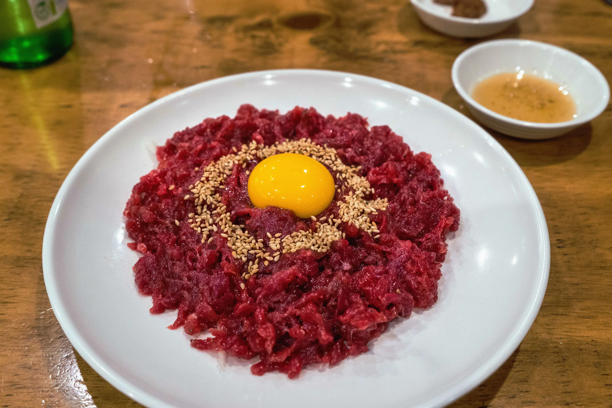 Raw beef sashimi yukke at Jamaejip in Gwangjang Market in Seoul Anyone who hasn’t had raw beef and raw egg yukke is missing out. I really believe that. It’s a double no-no for us Americans, I get it, but after living in Japan, I realized just how good it is. There are shops in Gwangjang Market that specialize in it, such as Jamaejip, and is worth eating at while drinking some beer or soju like the locals.