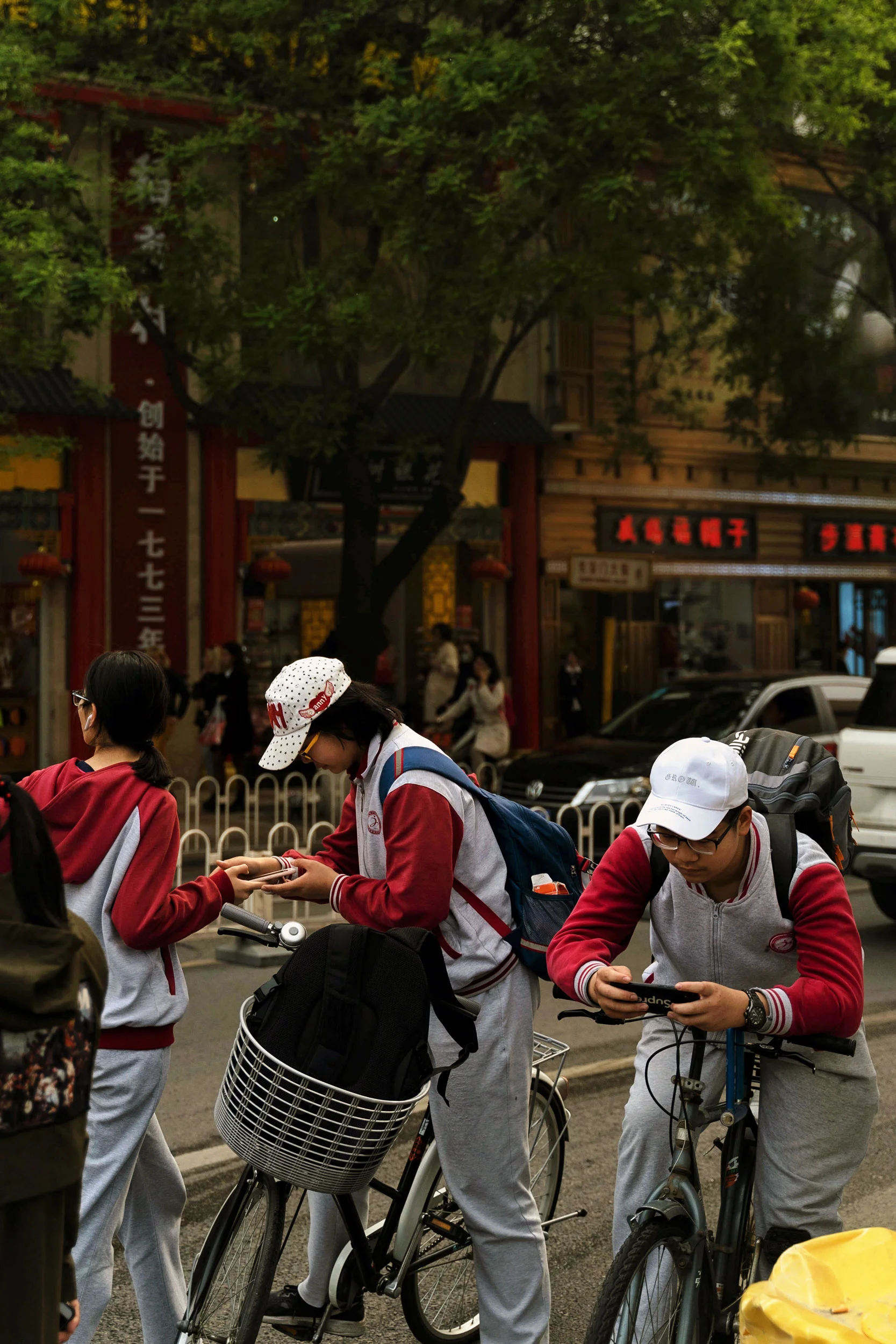 Some Chinese students take a break on their bicycles in Wangfujin.