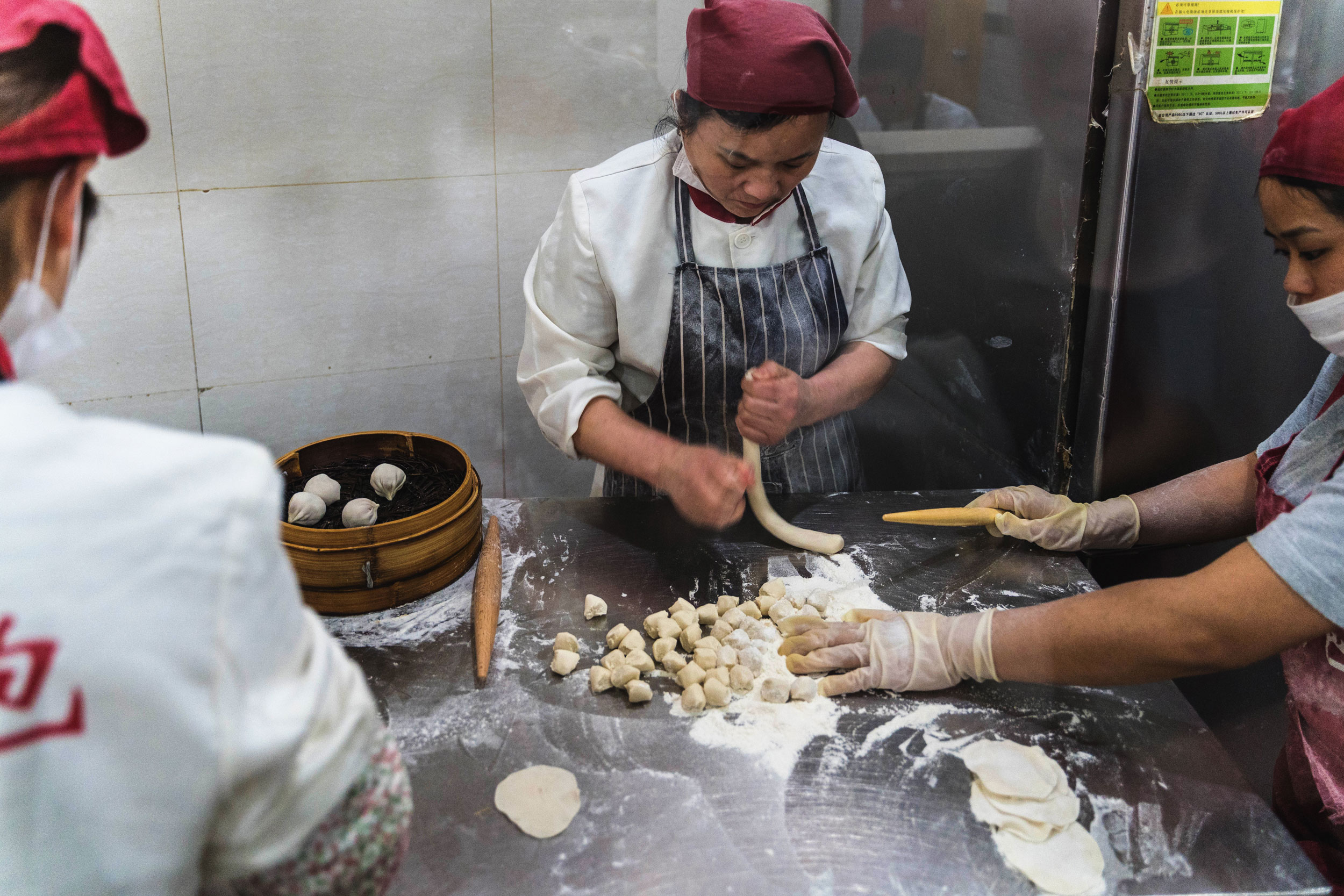 Chefs preparing xiaolongbao (Shanghai soup dumplings)