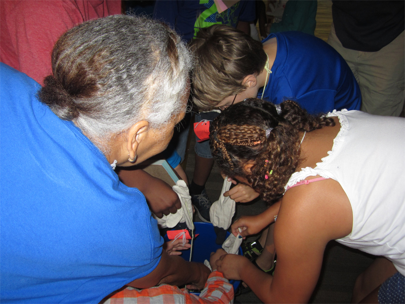 Helping a Vacation Bible School class with their Liberia offering collected during the week in work gloves.