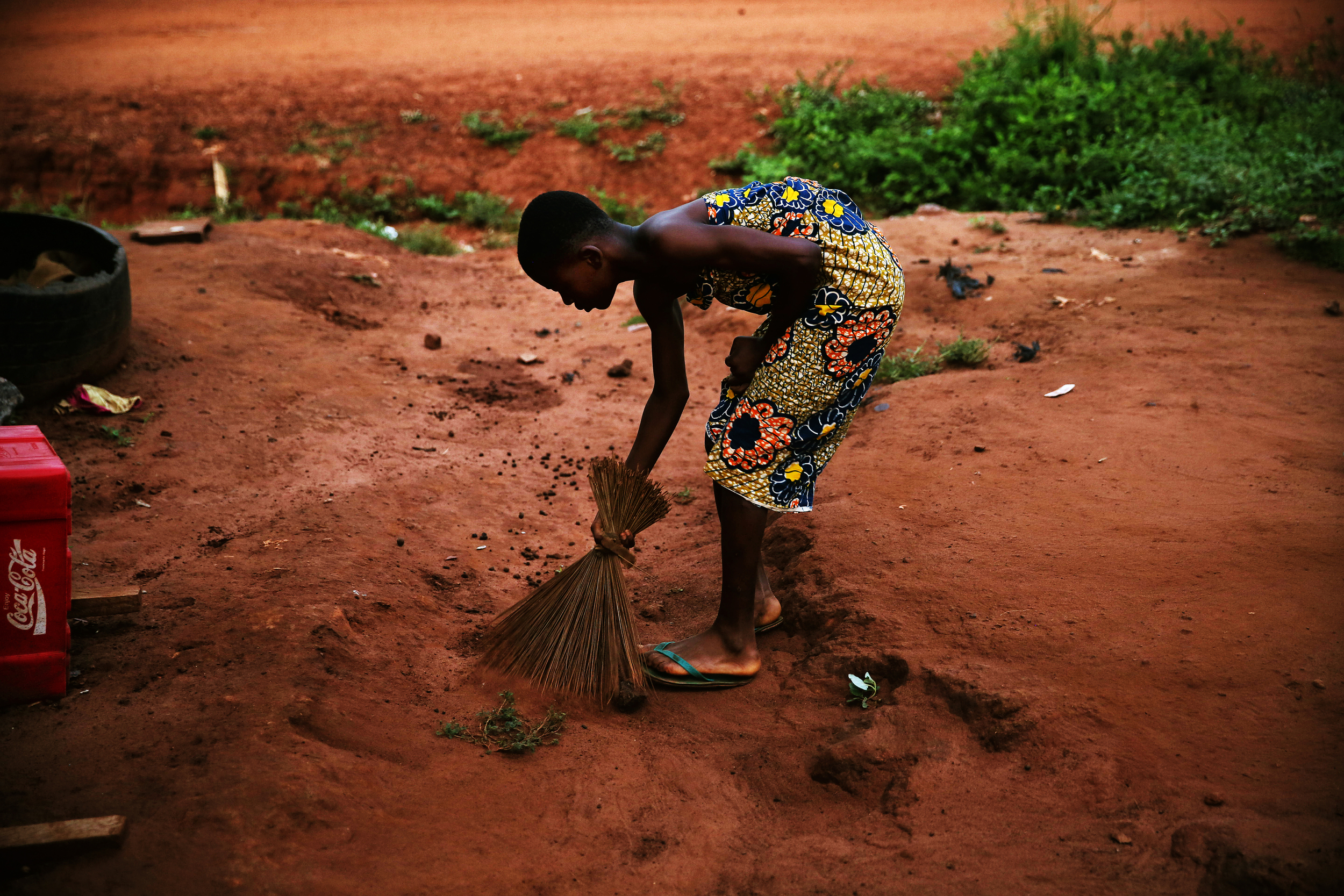  Every morning before school, Patience sweeps the yard around her house. 