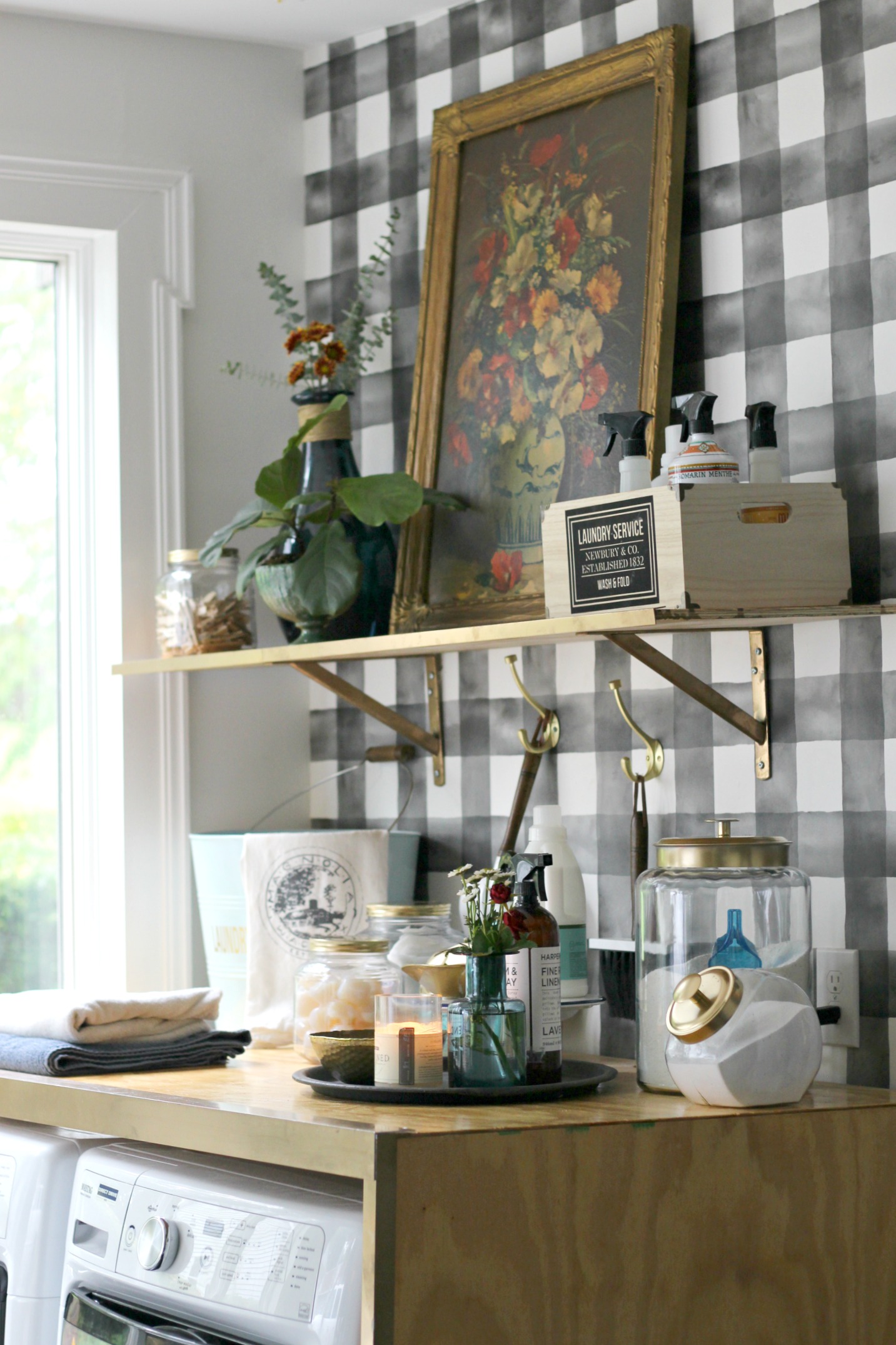 Brass hooks | Jars-large (spray painted tops gold) | Jars-medium (spray painted tops gold) | Floral painting: thrifted (similar here ) | Blue vases/jars: Homegoods (similar here + here ) | Laundry crate: Homegoods | Turquoise metal laundry tub: Homegoods | Magnolia towel