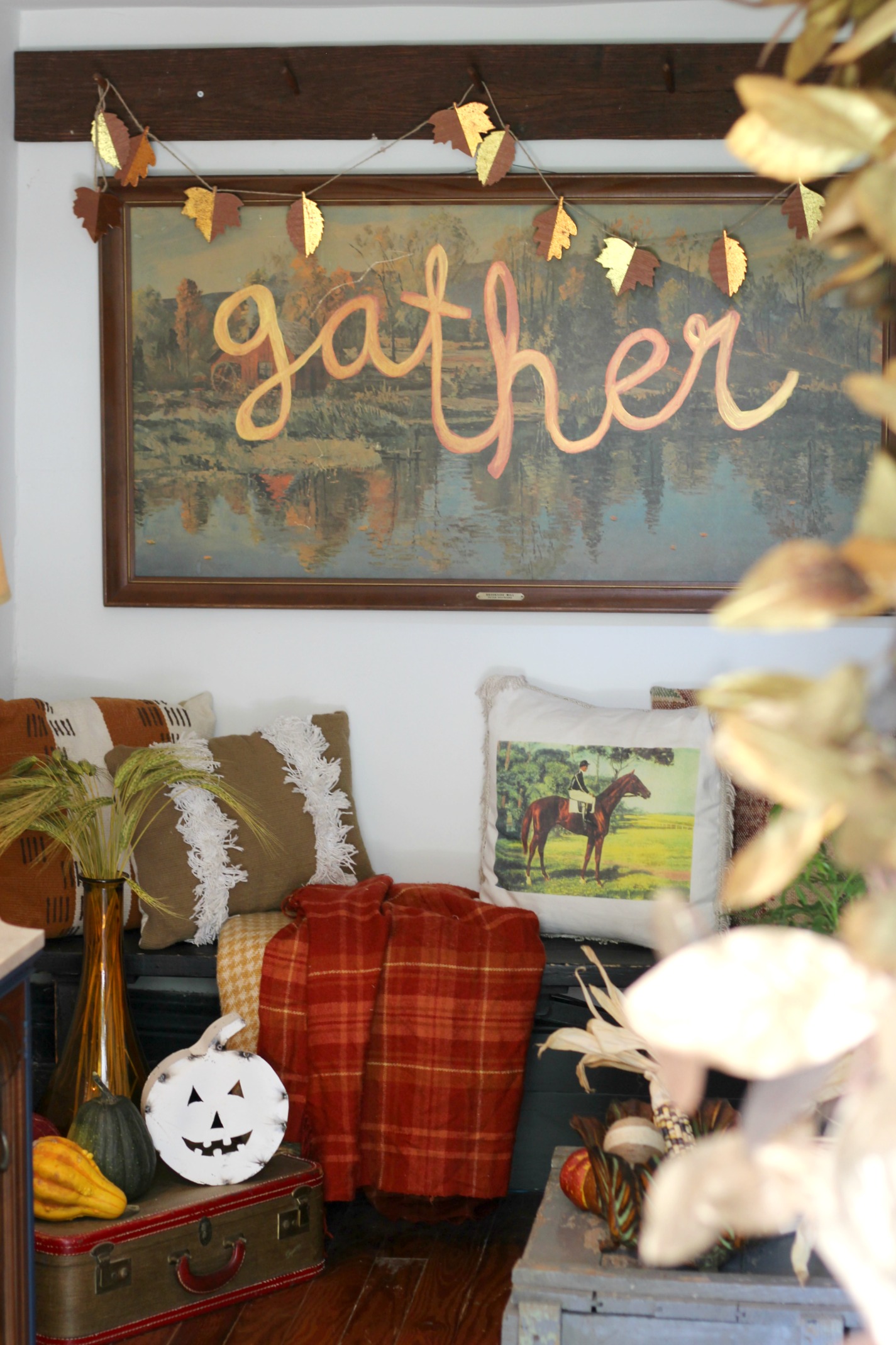 Leaf garland: Target (old) | Plaid blankets + horse pillow: thrifted | Fringe pillow: Target (old) | Suitcase: Thrifted | Amber vase: Marshall's | White metal jack-o-lantern: Sarah Smith Salvage