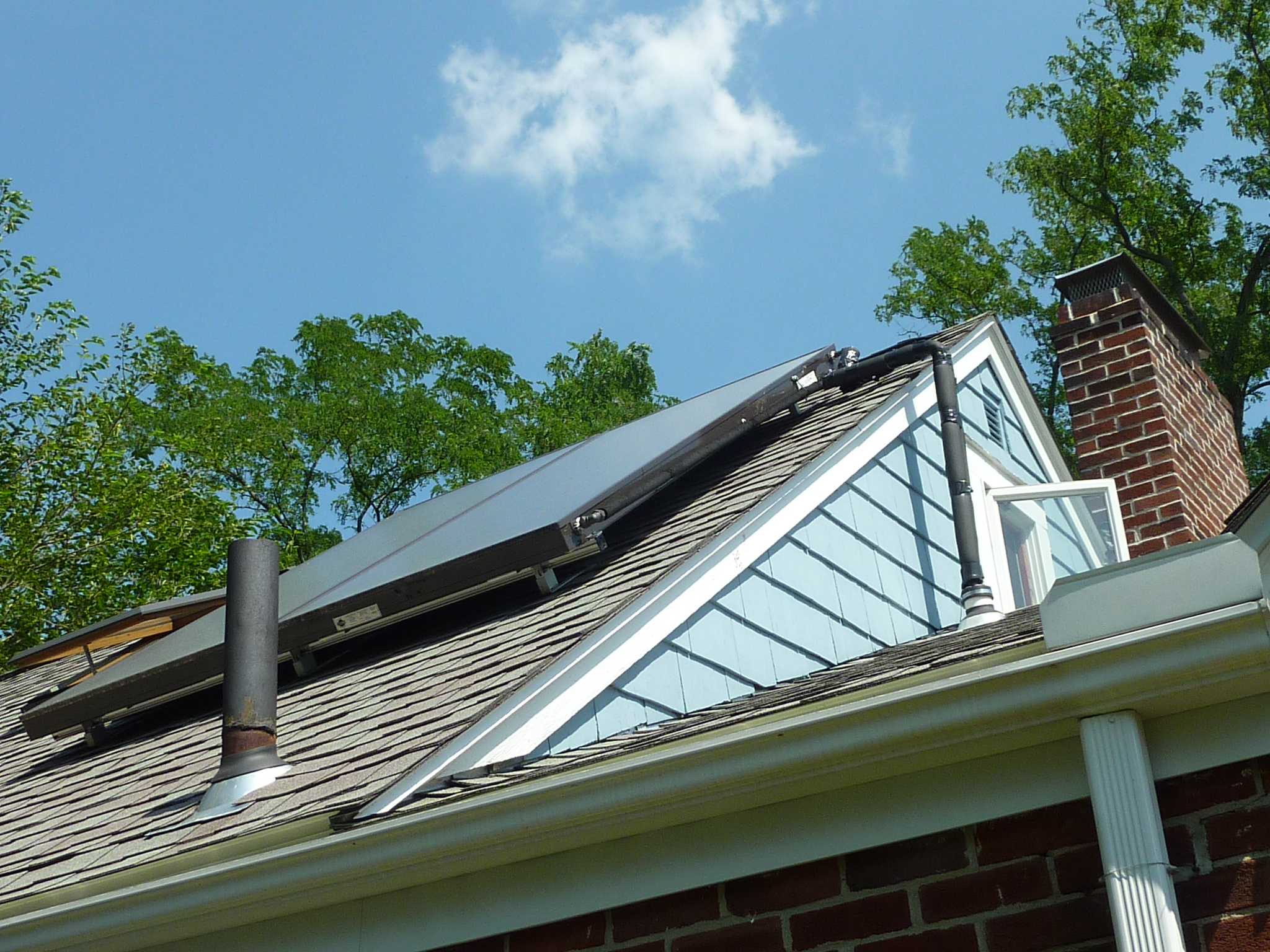 The pipe carrying the heat-transferring glycol from the collector to the basement goes down the side of the house and through a lower roof.