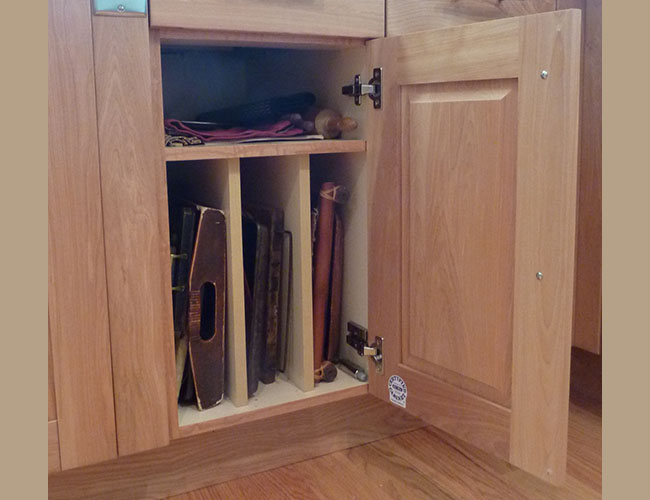 Cabinet dividers keep trays, cutting boards, and other items organized.