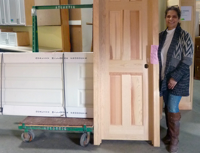 Evilyn Kalil picked up a bare wood door and a primed door. “It would have cost me a lot more somewhere else.”