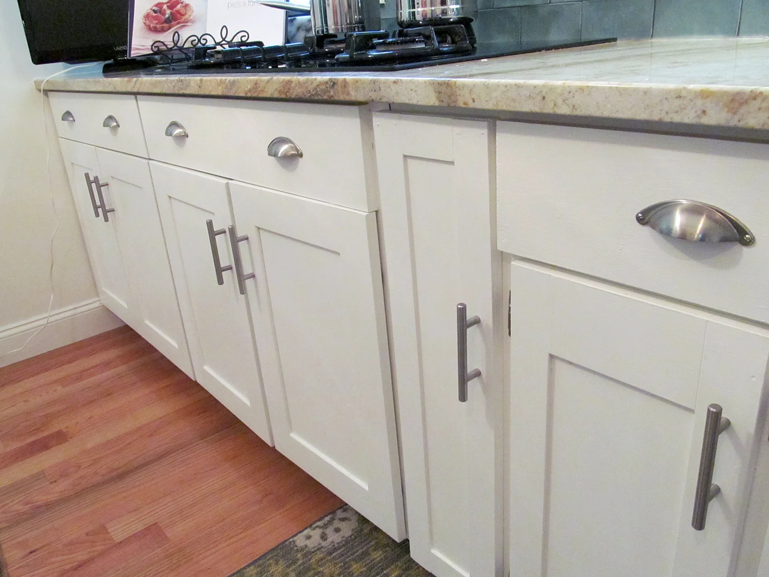 The cabinets were adapted to fit their new space. This base cabinet drawer was reconfigured so the cooktop could fit above it.