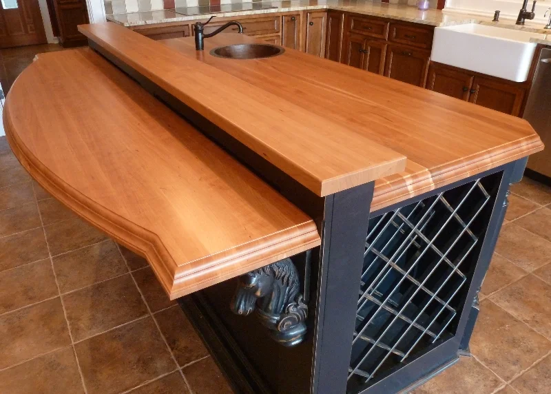 1.75" thick edge-grain American cherry tops with a sink cutout and custom edge treatment. Photo by The Southside Woodshop.