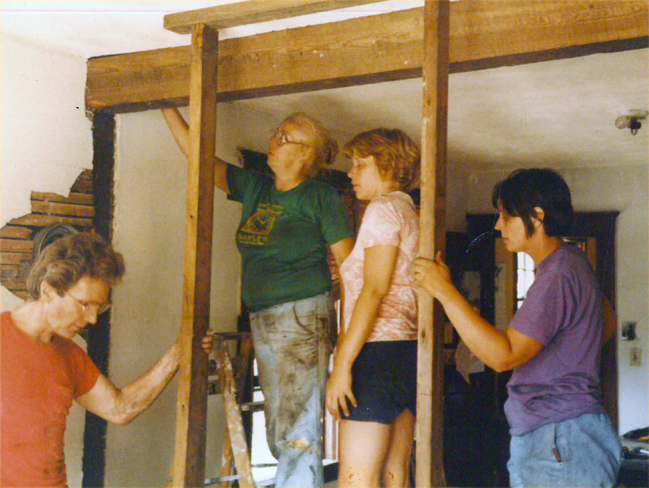 John, Lyn Garlord, Christine Rack, and Deborah Bernard work to remove a bearing wall.