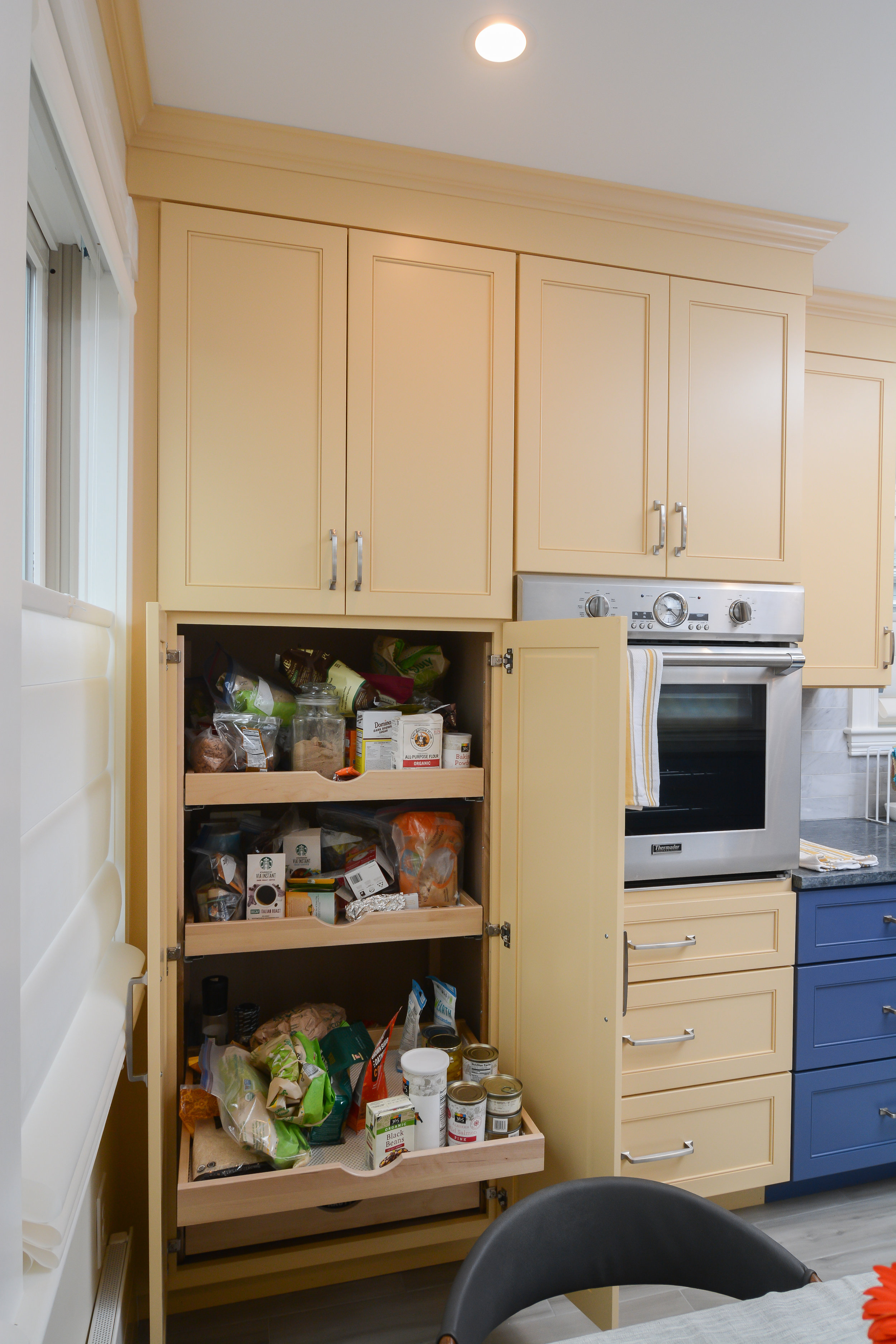 Pantry cabinet has a filler on the left to accommodate windowsill &amp; baseboard heater