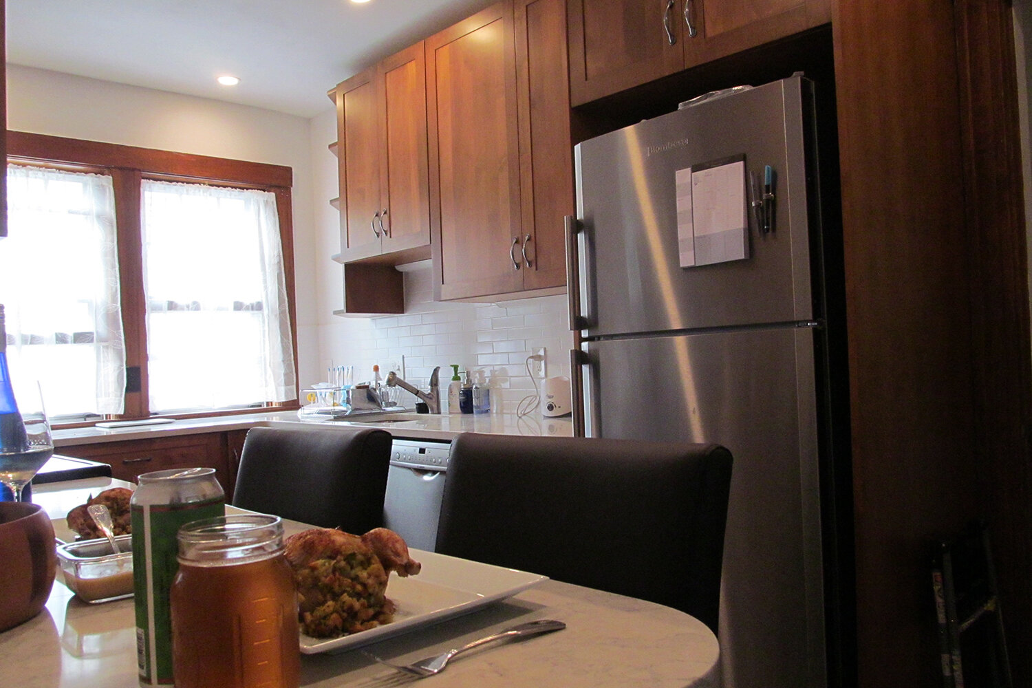 Restored double-hung windows, original to the house, shed light on the sink area.