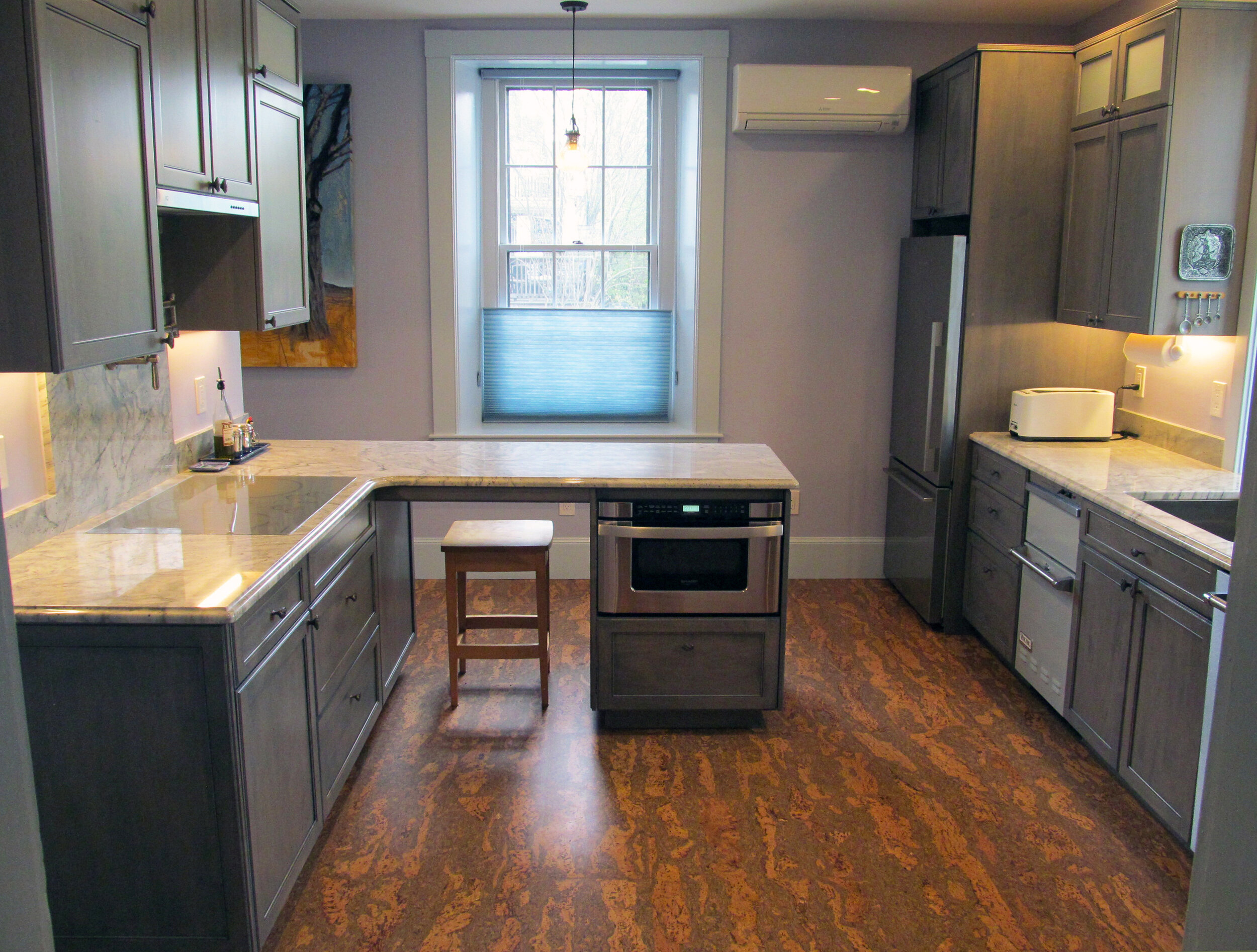 This remodeled Roslindale kitchen integrates a previous pantry and adds a peninsula for storage and seating. 