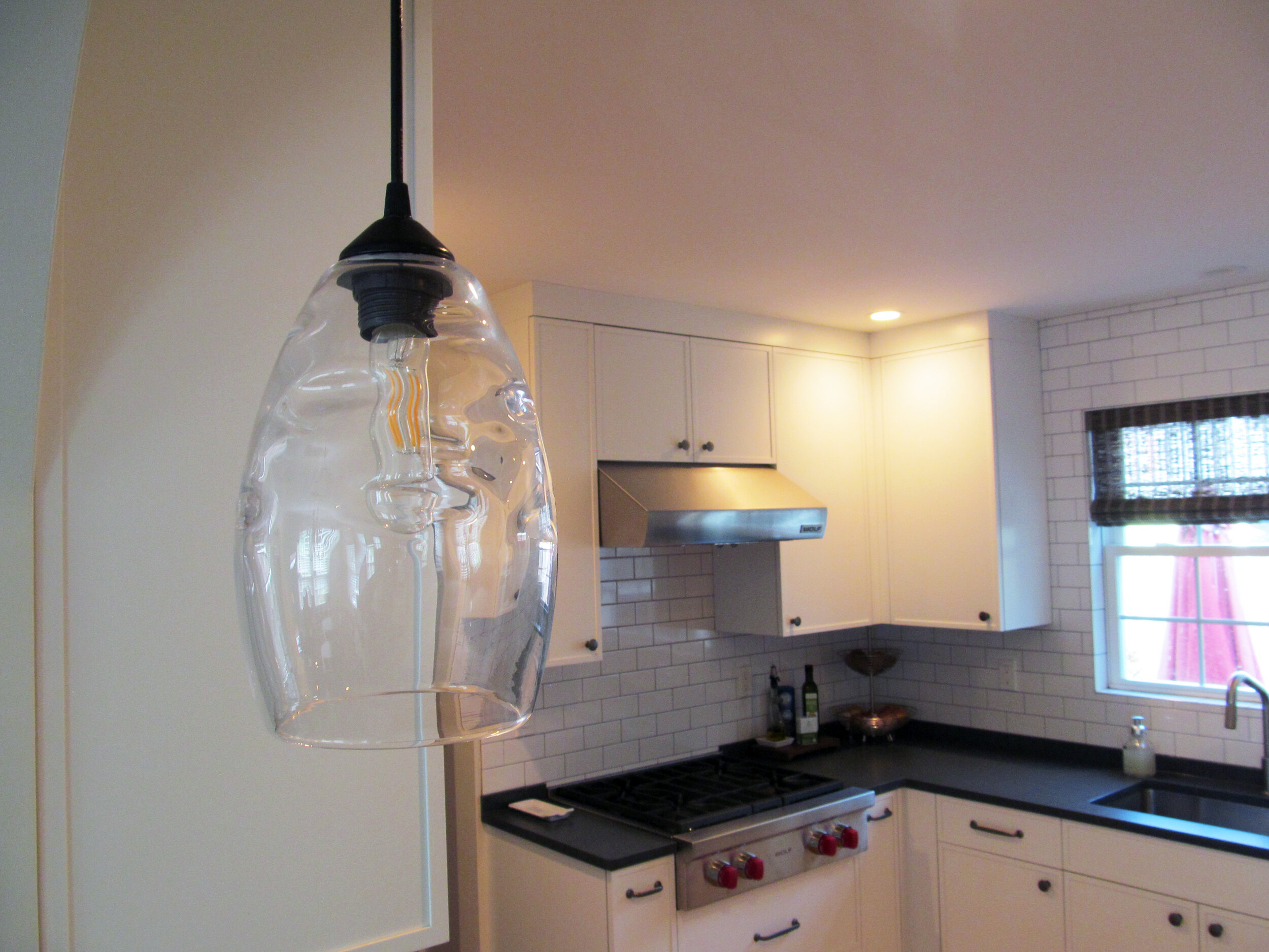Two blown glass pendants over the peninsula are the center of attention.