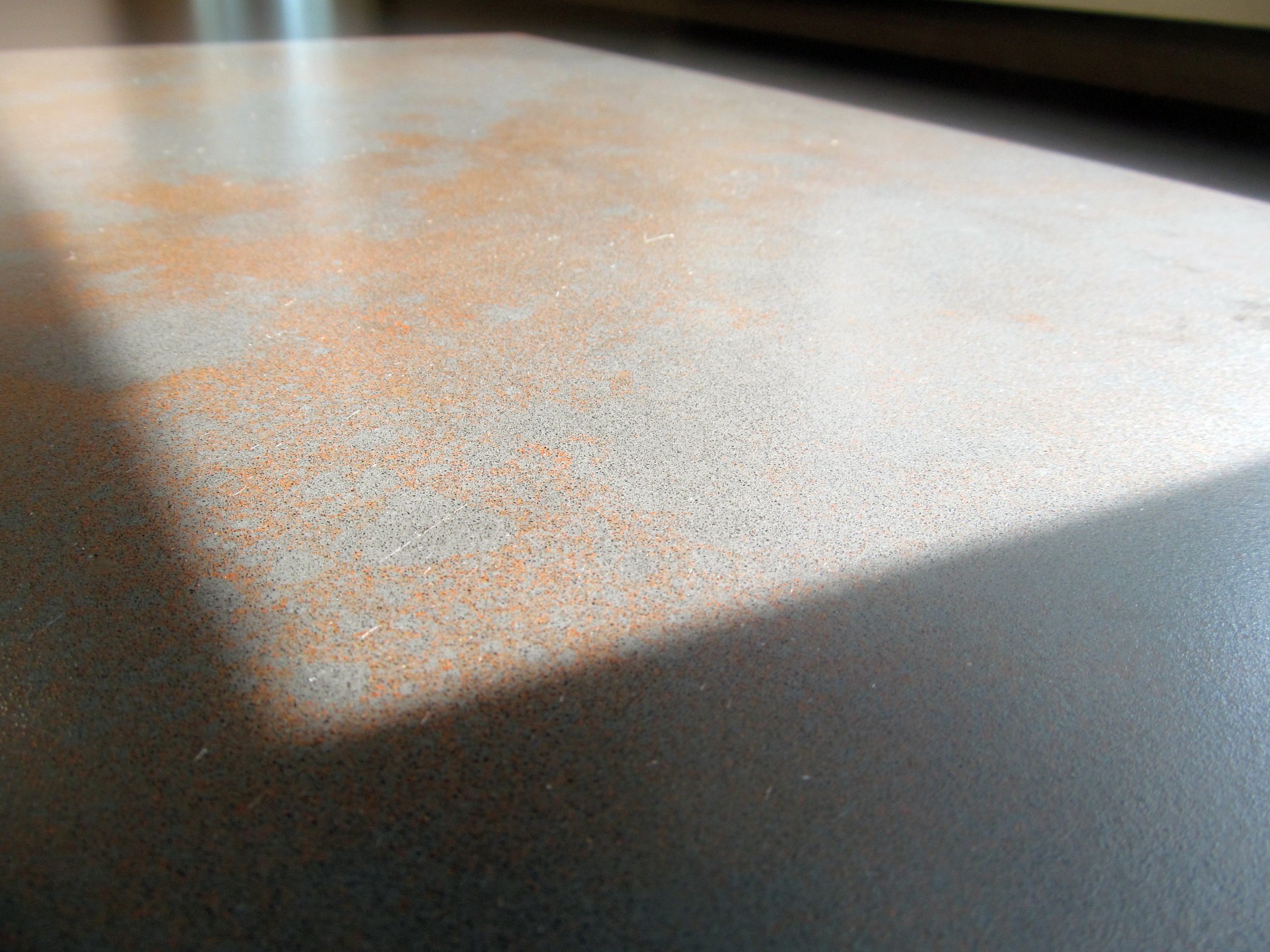 The countertop's subtle earth tone variations are visible in the sun. (Caesarstone quartz Oxidian 4735)