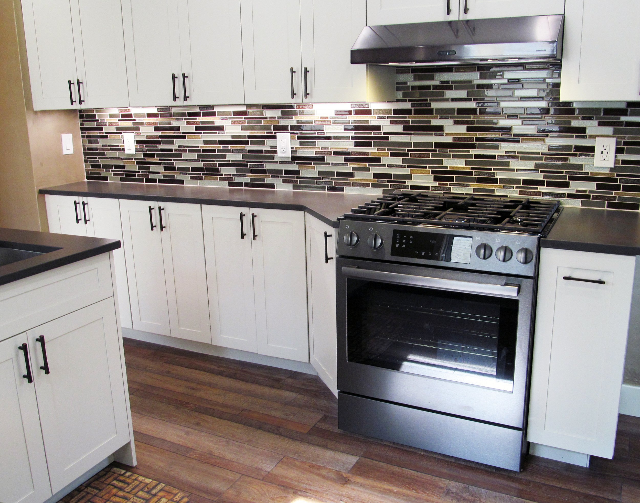 Shallow cabinets to the left of the range add storage to a previously unused space