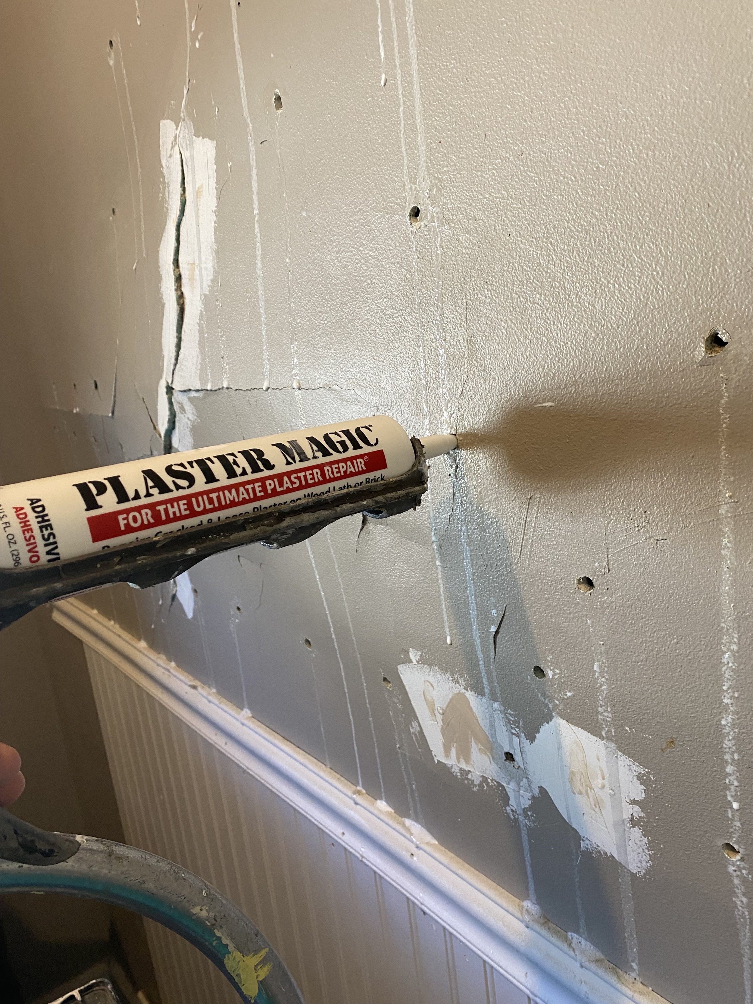 Adhesive reattaches the plaster to the lath