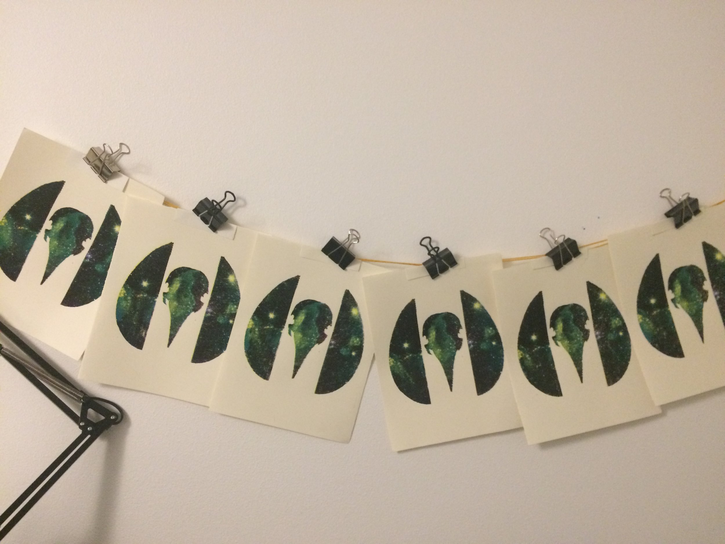 Everything about my studio is DIY, but this drying situation has to be the most! It's literally paper, binder clips, and yarn tacked to the wall. It works in a pinch, but the paper will warp during drying and need to be flattened. 