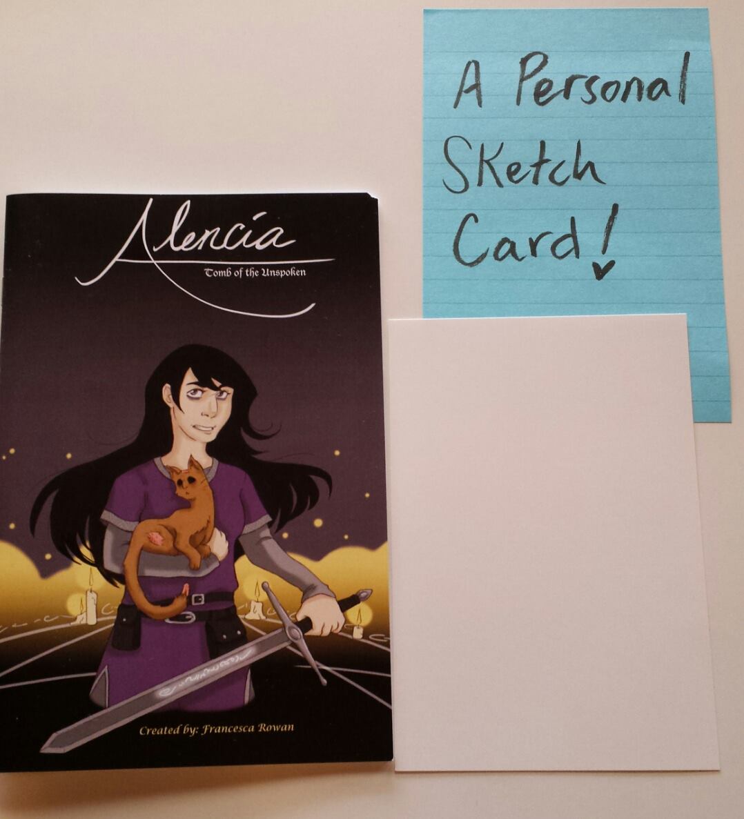 "Art Card Pack," featuring the new Alencia book and a personalized A6 sized art card. The winner will get to choose what I draw on it!