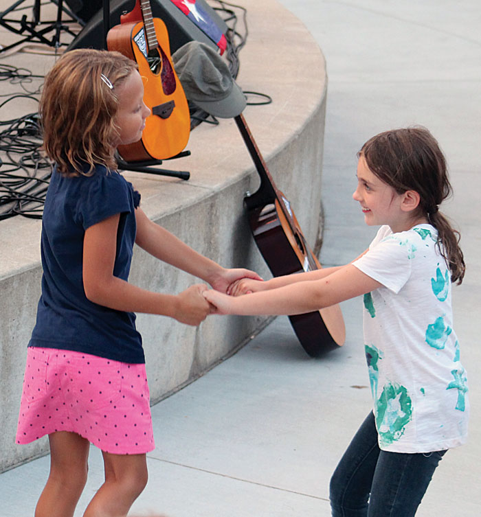  Two girls danced to the music of Bob Dylan Aug. 1 at Veterans’ Memorial Amphitheater in St. Louis Park. (Sun Sailor staff photo by Seth Rowe) 