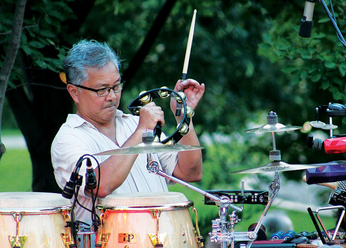  Percussionist Ralph Dacut plays the tambourine during the annual “Salute to the Music of Bob Dylan” Aug. 1 at Veterans’ Memorial Amphitheater in St. Louis Park. (Sun Sailor staff photo by Seth Rowe) 
