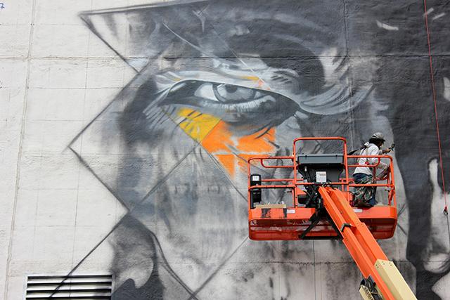 If you drive, walk, bus or bike downtown or use light rail, you can watch the new Bob Dylan mural take shape over the next two weeks. (Photo by Bailey Cahlander)