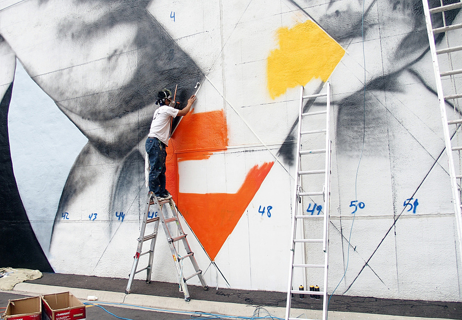  Minneapolis artist Yuya Nigishi stood precariously on a ladder to tape a line on the mural on August 27, 2015. 