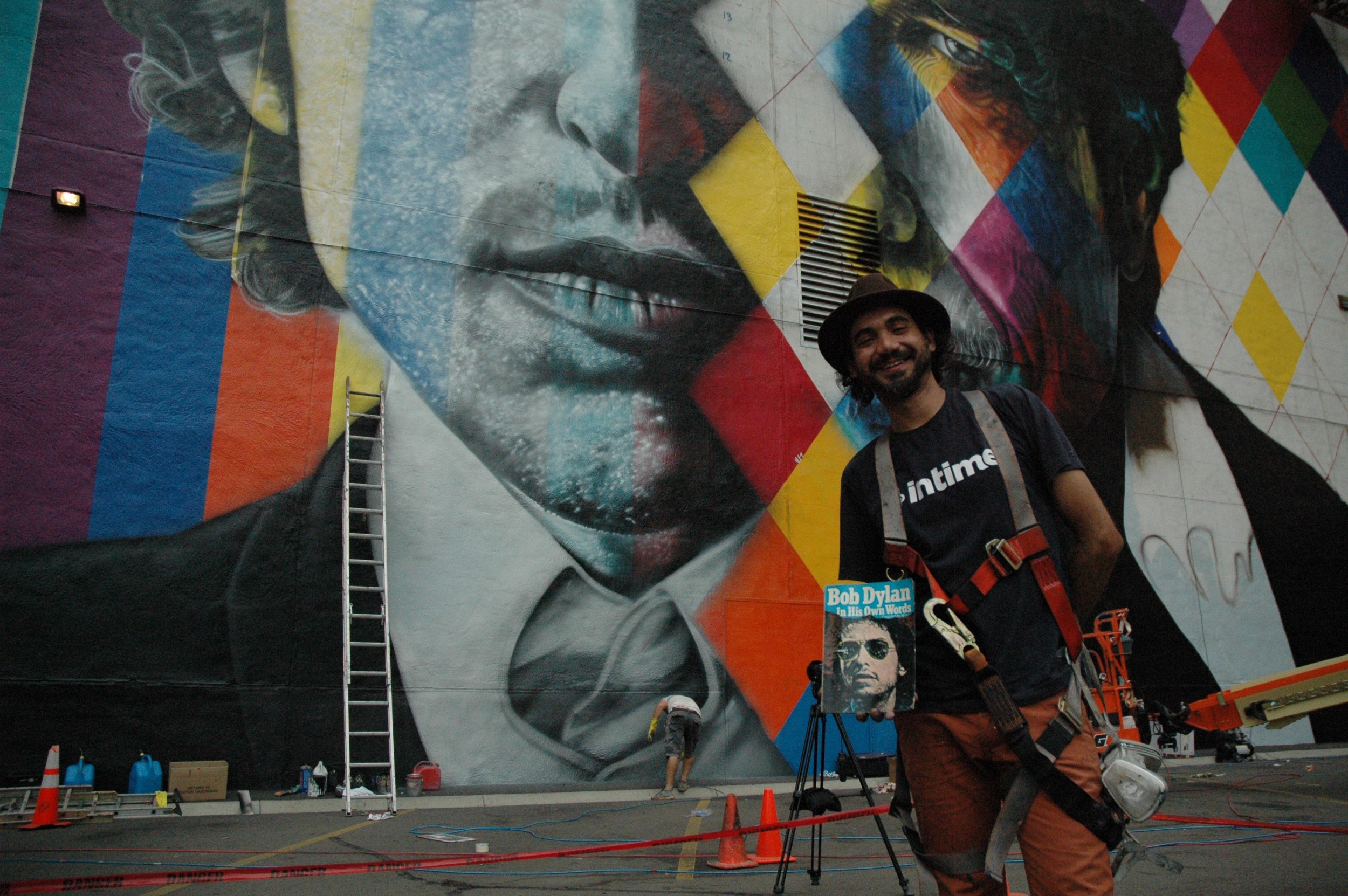 Eduardo Kobra and a copy of Dylan's autobiography, which serendipitously was found in the building that he's painting.