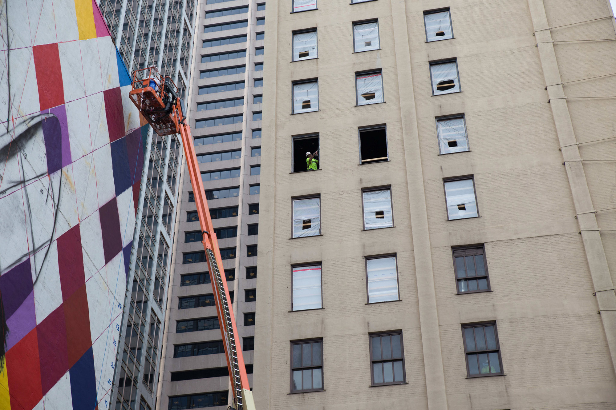 Minneapolis muralist, Erin Sayer, working on the upper reaches of the mural.