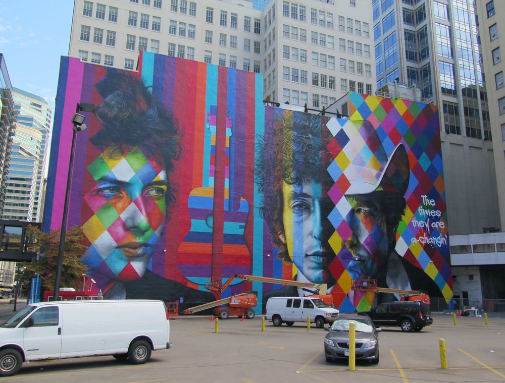  The blank white wall facing the corner of 5th and Hennipen Av has transformed into a mural by Brazilian artist Eduardo Kobra and crew. Monday 9/07/2015 - last in time lapse series  