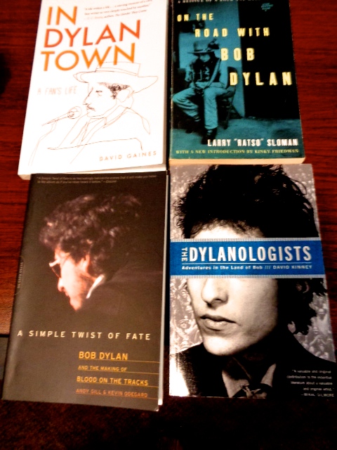 Four books signed by their respective authors.